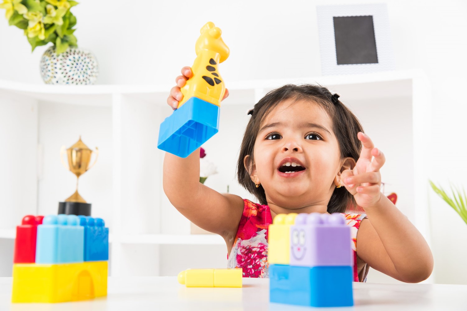 cute-little-indian-asian-girl-enjoying-while-playing-with-toys-blocks-sitting-table-scaled